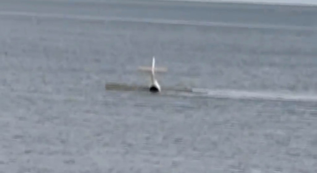 Small airplane crash landing in the ocean.