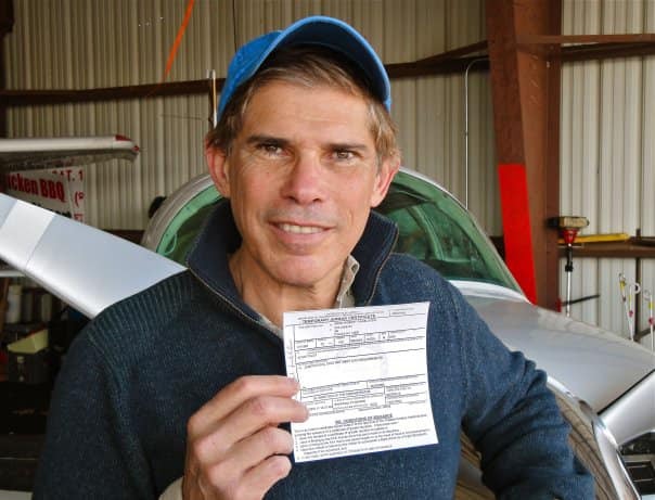 Pilot holding aircraft paperwork.