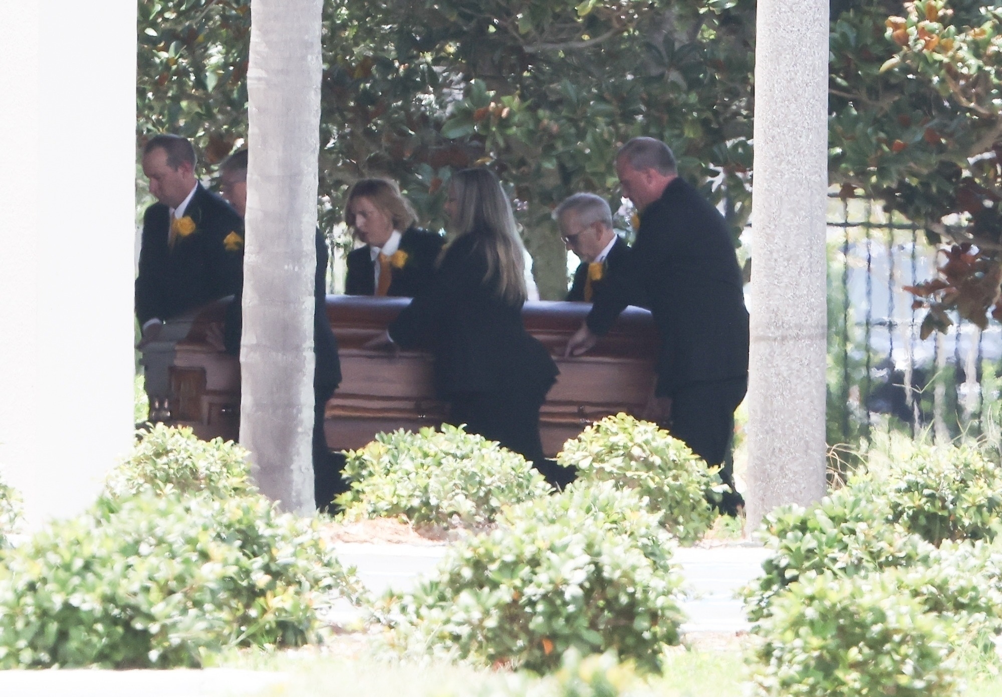 Hulk Hogan's casket being carried into the funeral home.