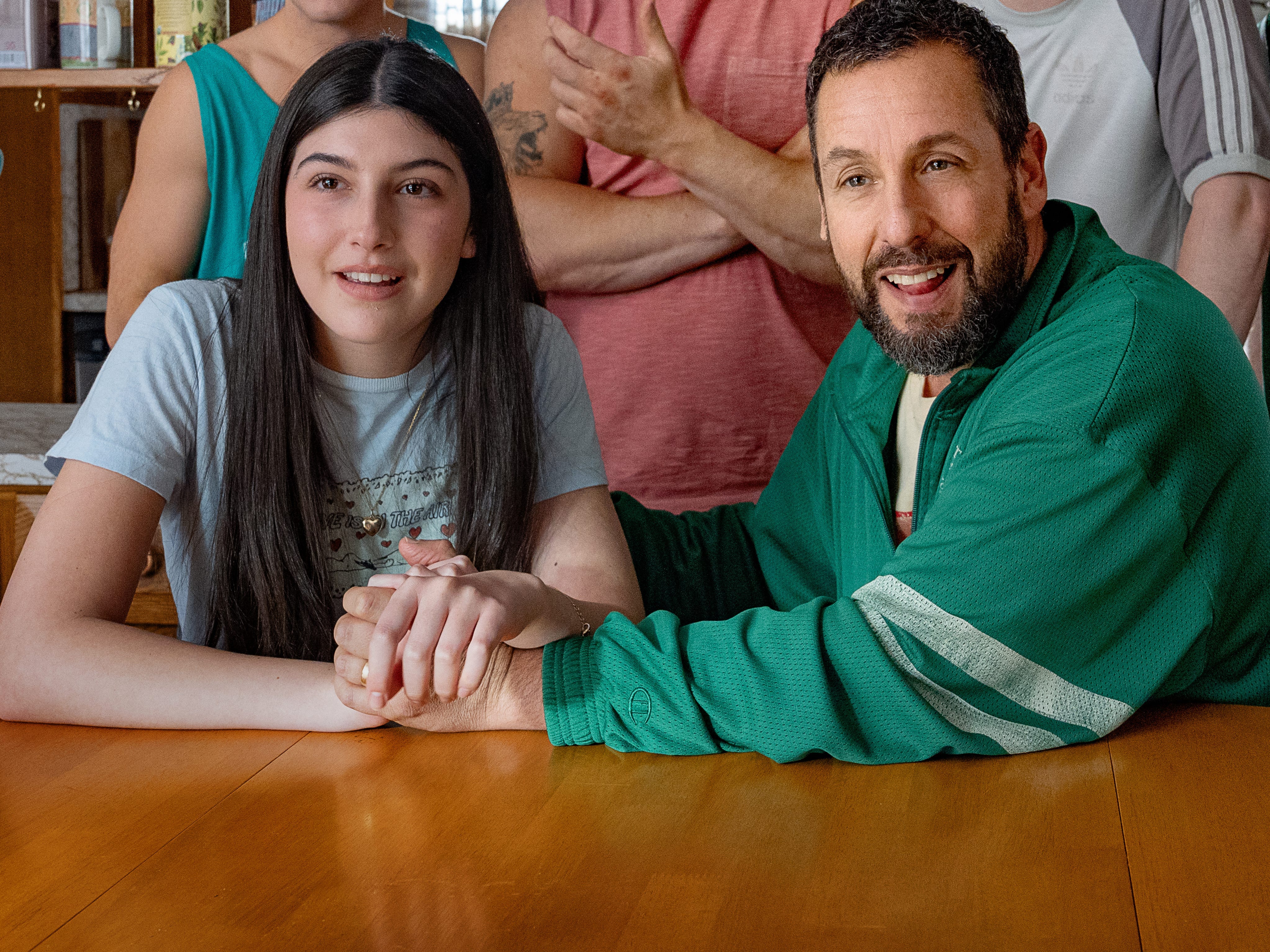 Sunny and Adam Sandler holding hands
