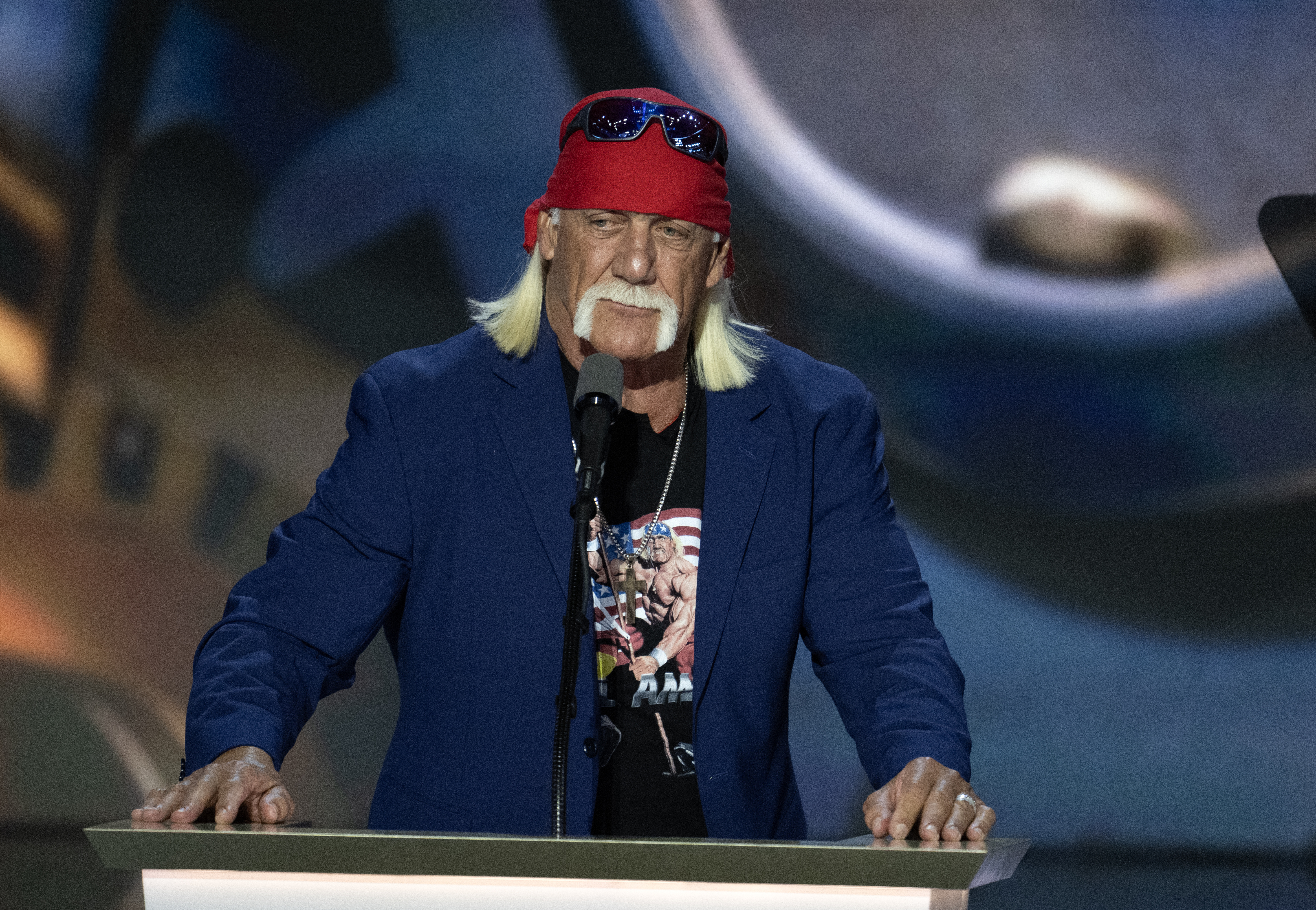 Hulk Hogan stands at a pulpit. 