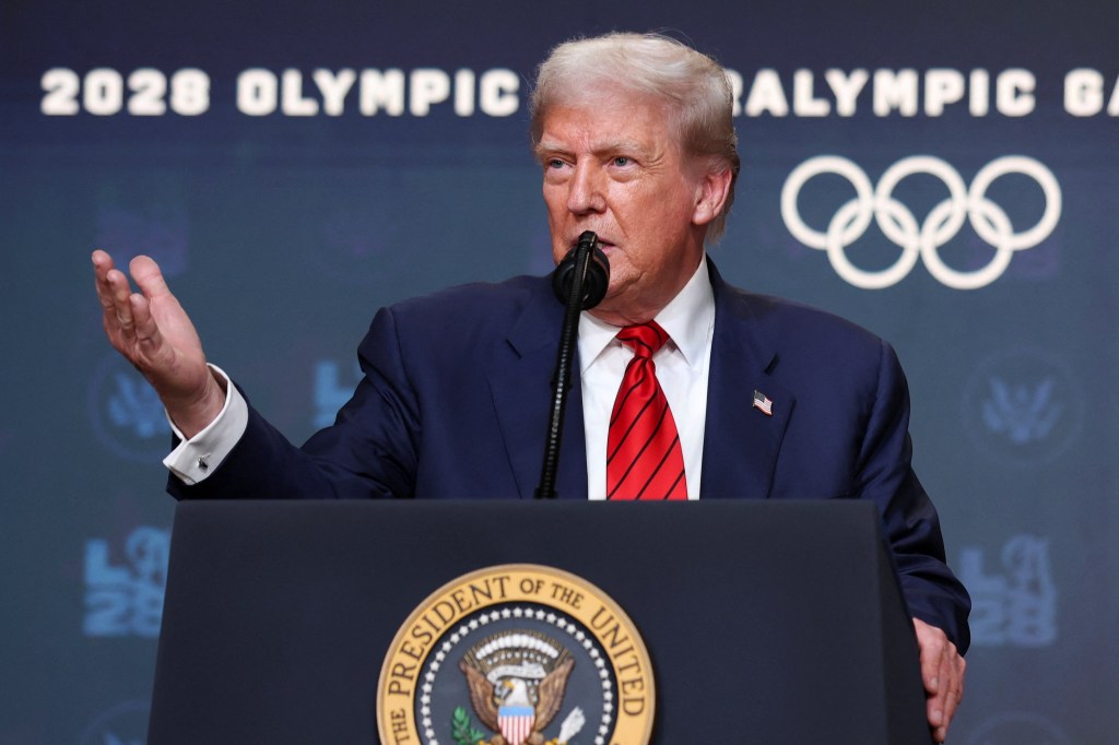 President Trump speaking at a podium about the 2028 Olympics.