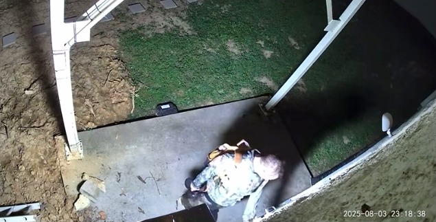 spotted on Sunday night in Jackson holding a rifle and wearing camouflage clothing with a brown backpack, appearing to try to open a door and enter a building