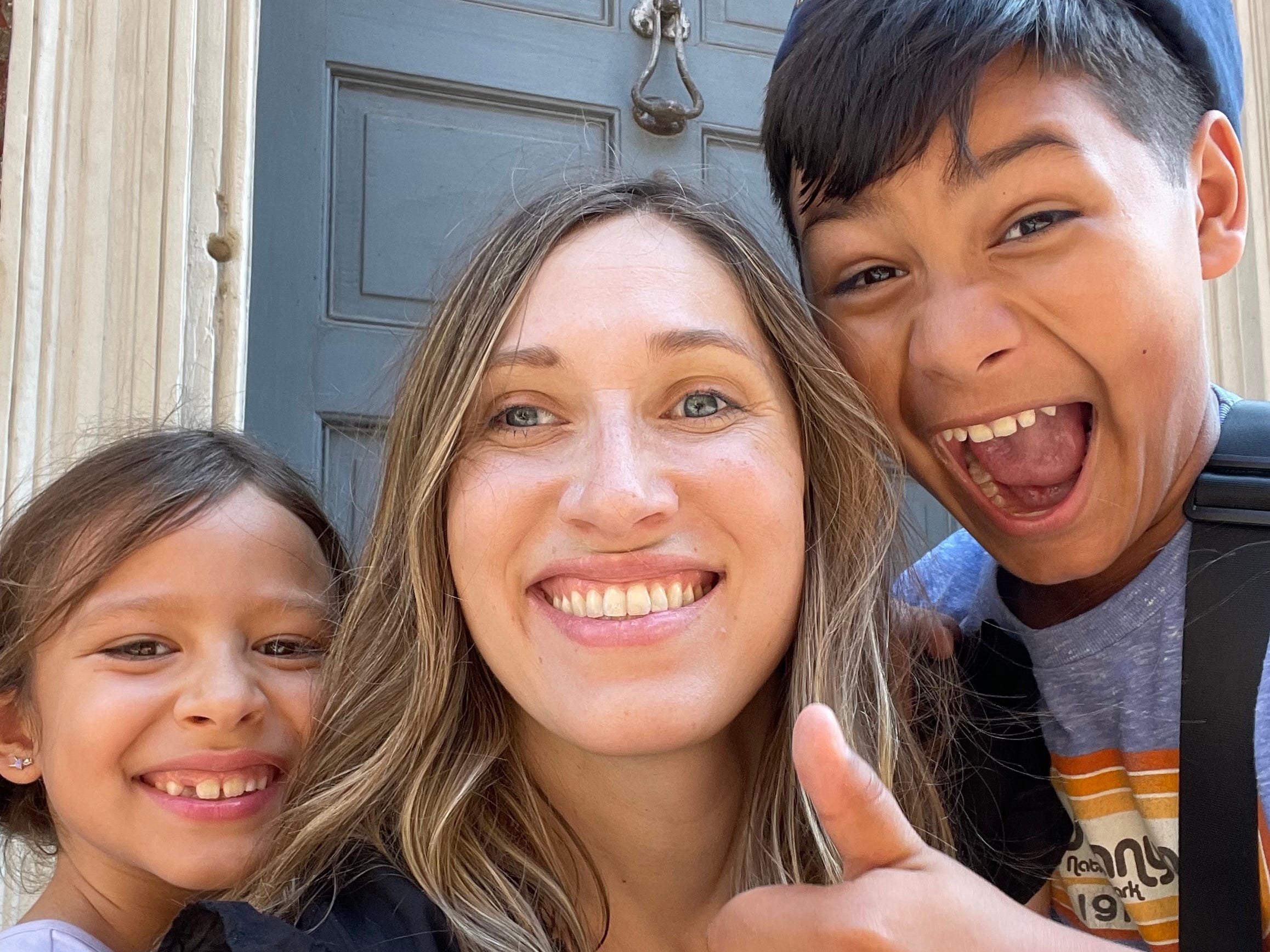The author with her two kids at home smiling.