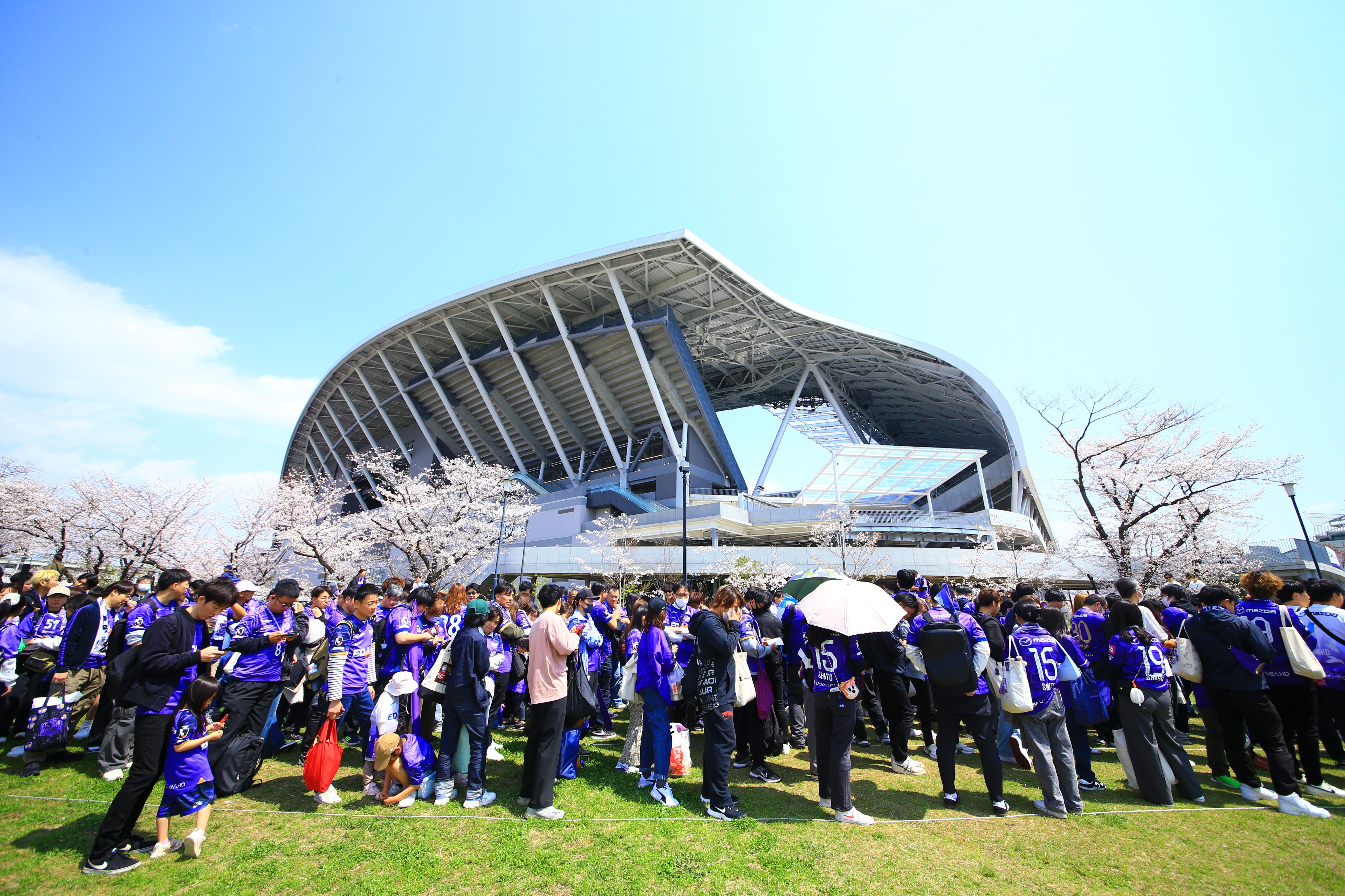 sports fans waiting outside soccer field in hiroshima, japan