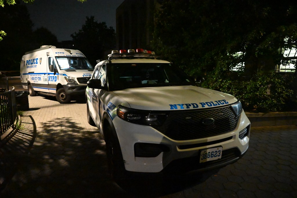NYPD vehicles at a crime scene.