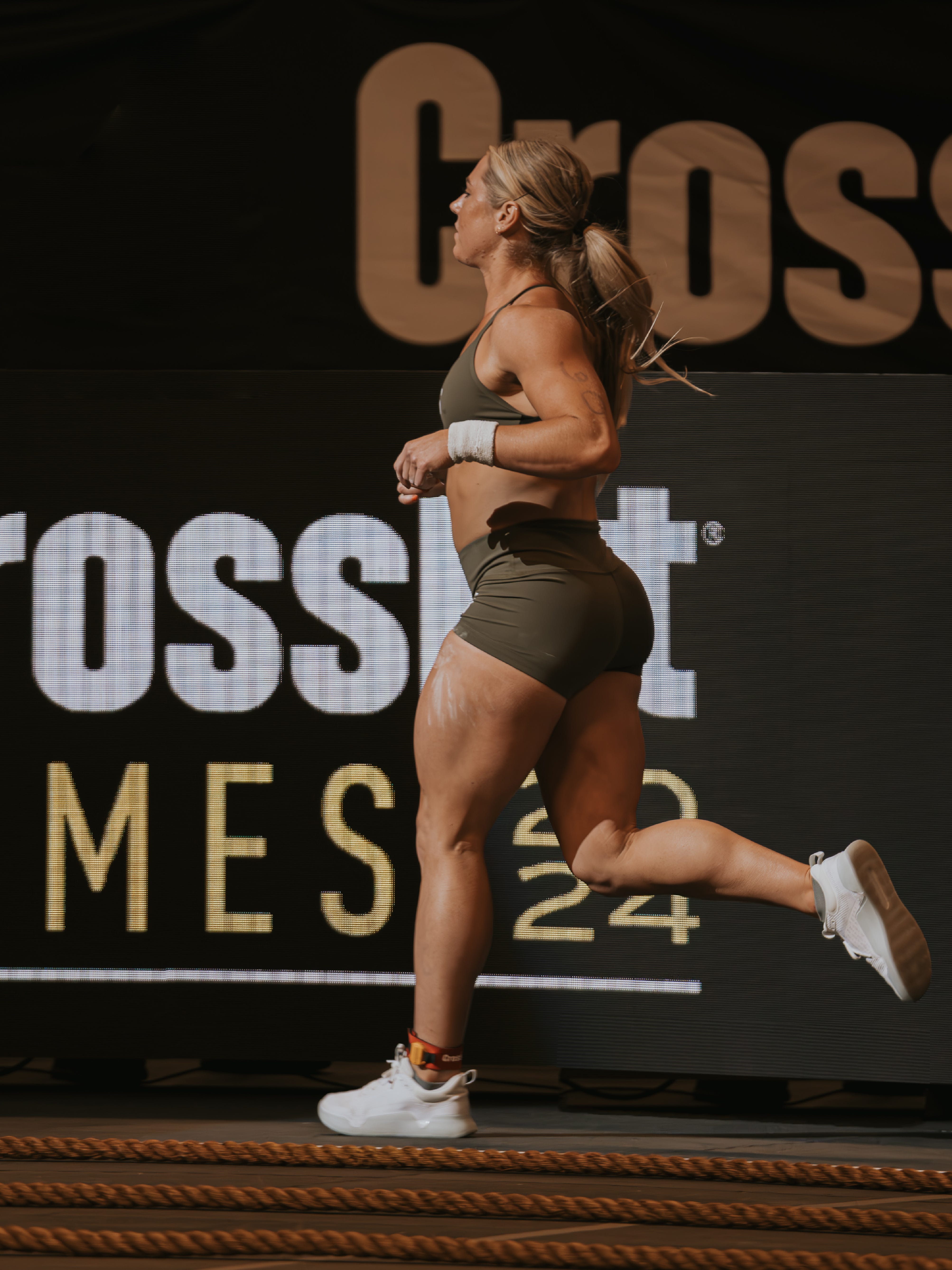 Athlete Brooke Wells running in a CrossFit Games event.