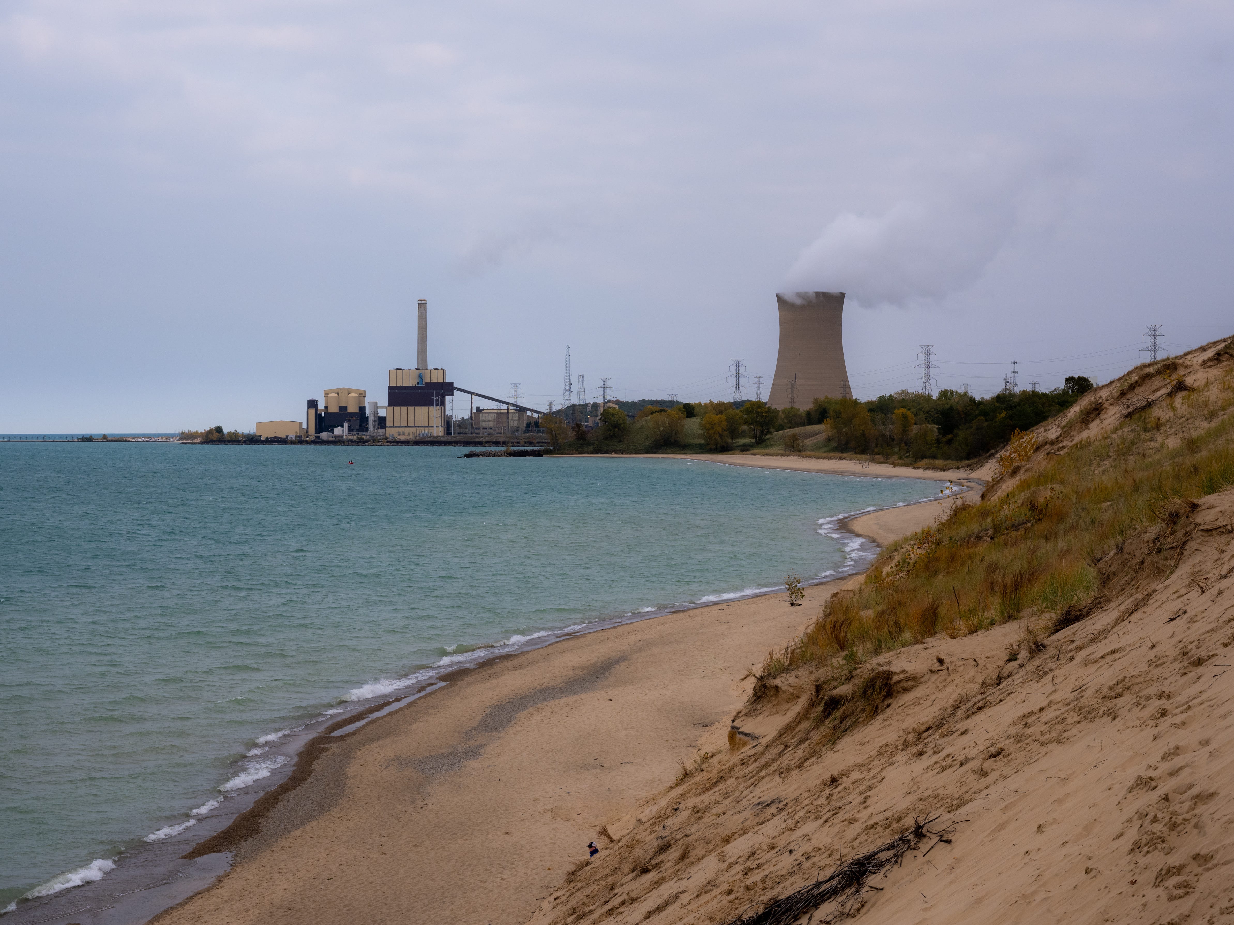 Distant view of a power plant on the border of Indiana Dunes National Park and Lake Michigan.