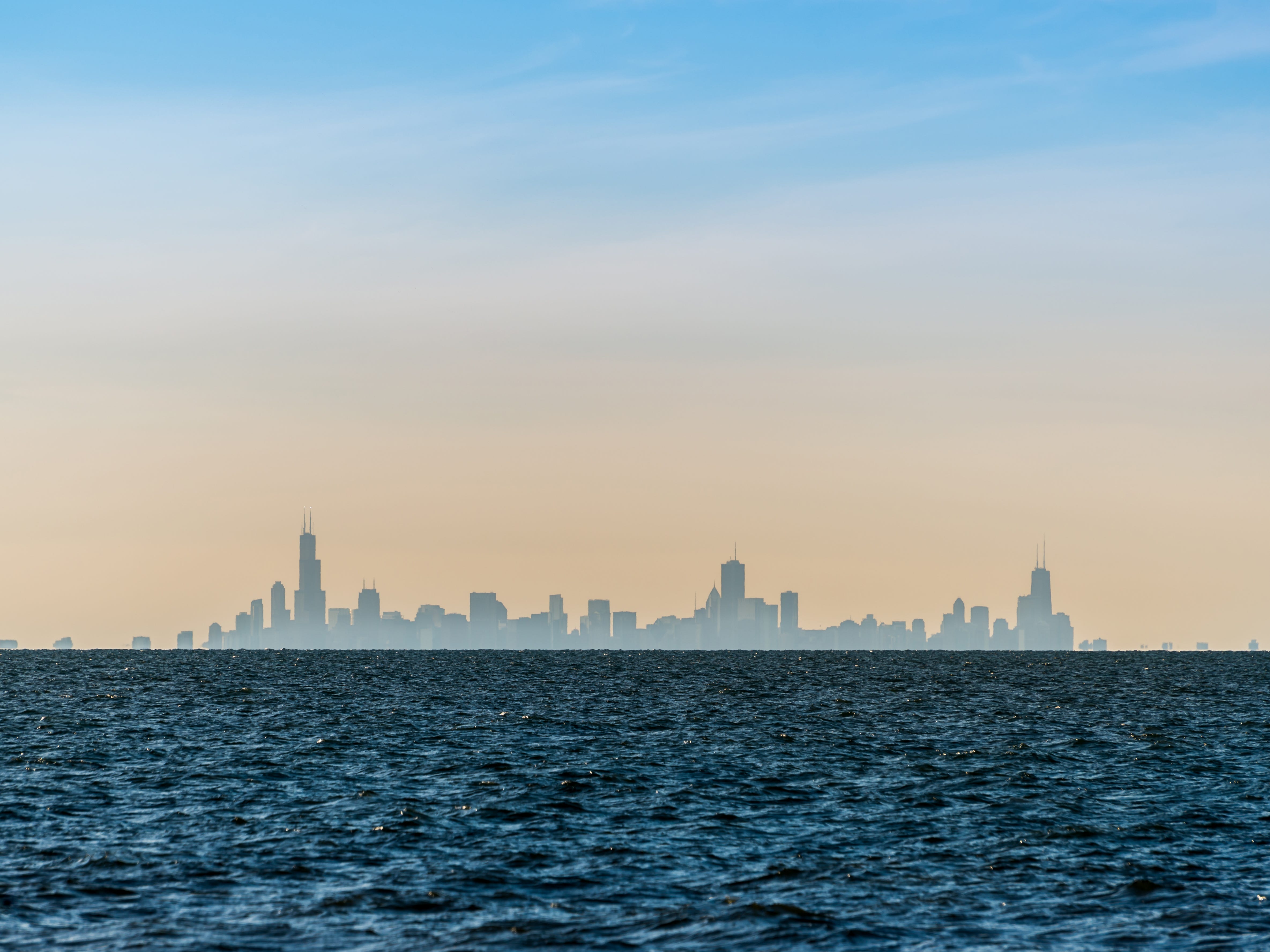 The Chicago skyline seen from Indiana Dunes National Park over Lake Michigan.