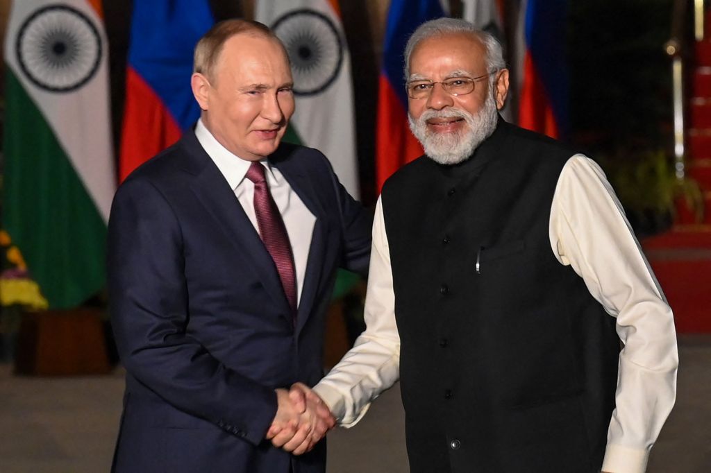 Modi and Putin shaking hands.