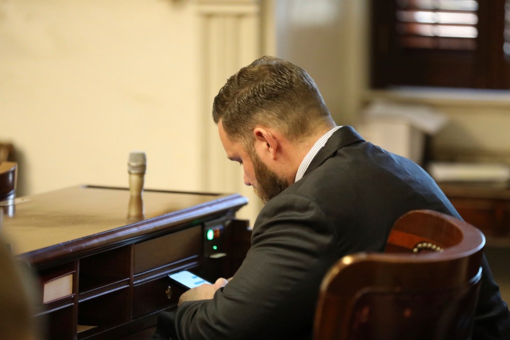 A South Carolina lawmaker looking down at his phone.