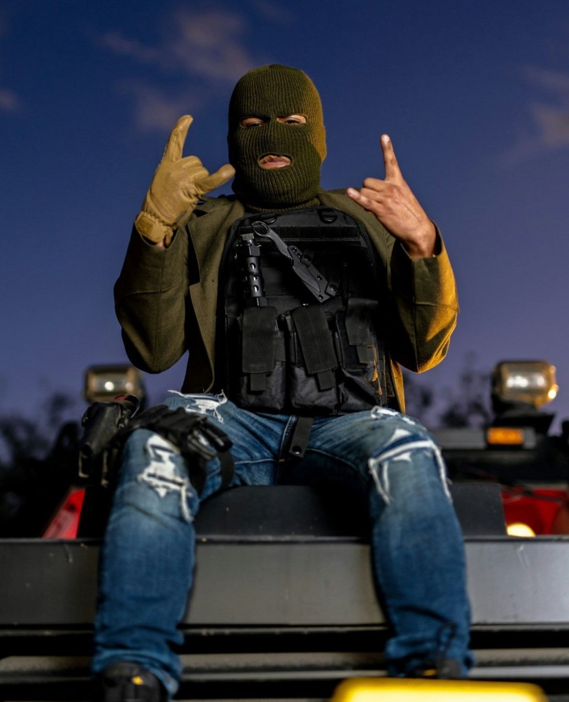 El Makabelico, a narco-rapper, posing for a photo.