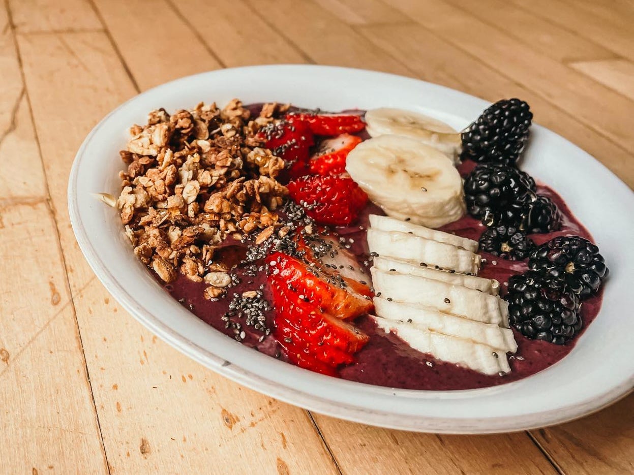 smoothie bowl with granola, chia seeds, strawberry, banana, and blackberries