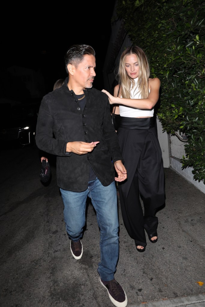 Actress Margot Robbie is seen walking with actor Jay Hernandez to her waiting Uber vehicle after attending a party at the Chateau Marmont Hotel in Los Angeles.