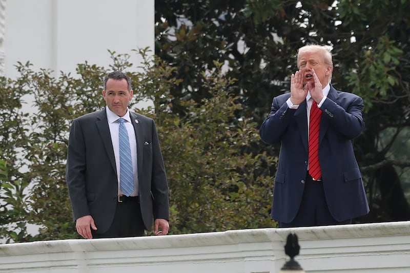 President Donald Trump speaks to the media from the roof of the West Wing of the White House as he takes a tour on August 05, 2025 in Washington, DC. Trump has undertaken several renovation projects at the White House to include the construction of a concrete patio at the Rose Garden.