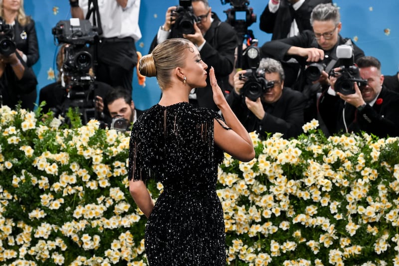 Sydney Sweeney blows a kiss to photographers on the red carpet at the 2025 Met Gala on May 5, 2025 in New York City.