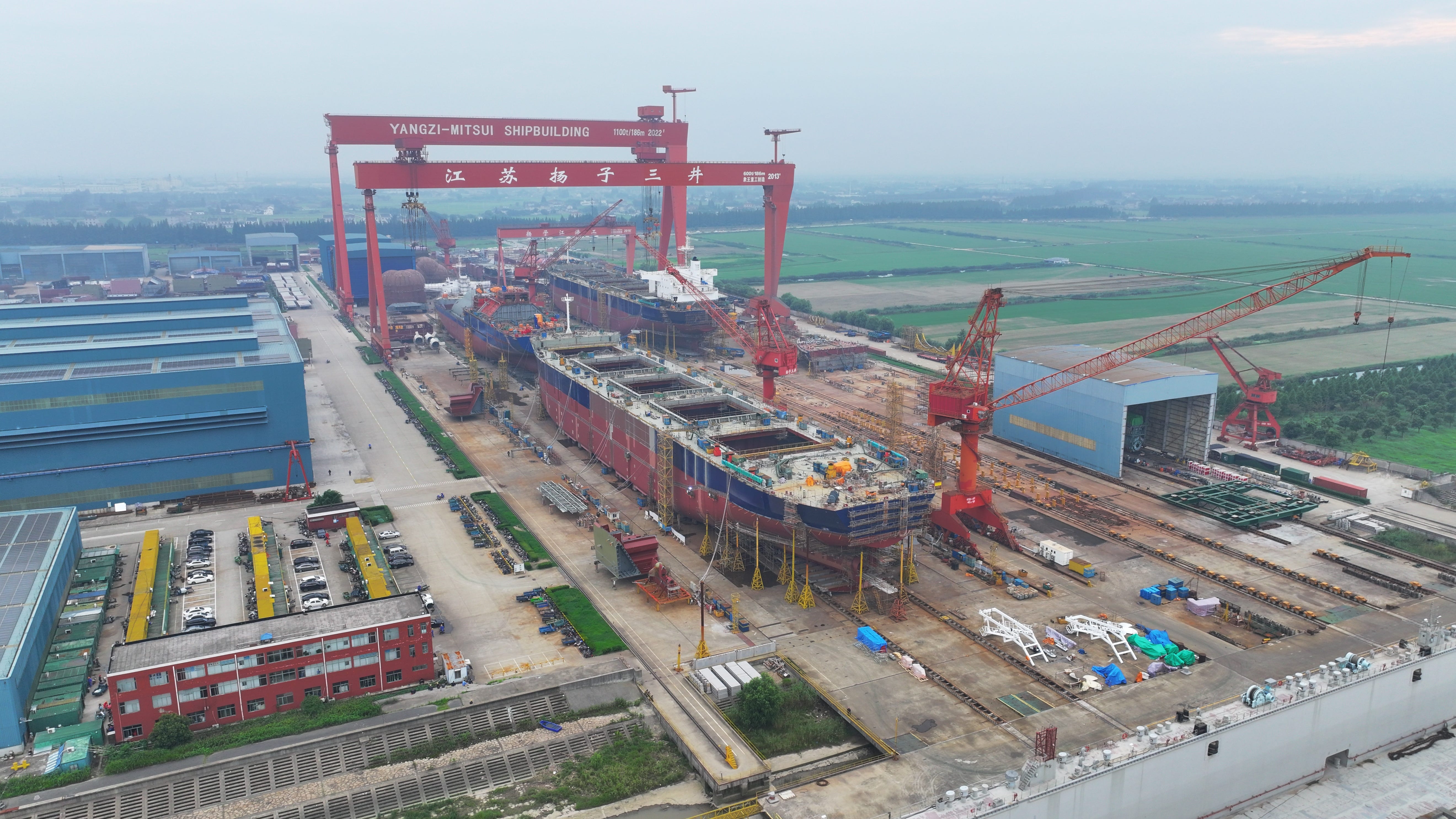 An aerial view of several ships under construction at a shipbuilding enterprise.