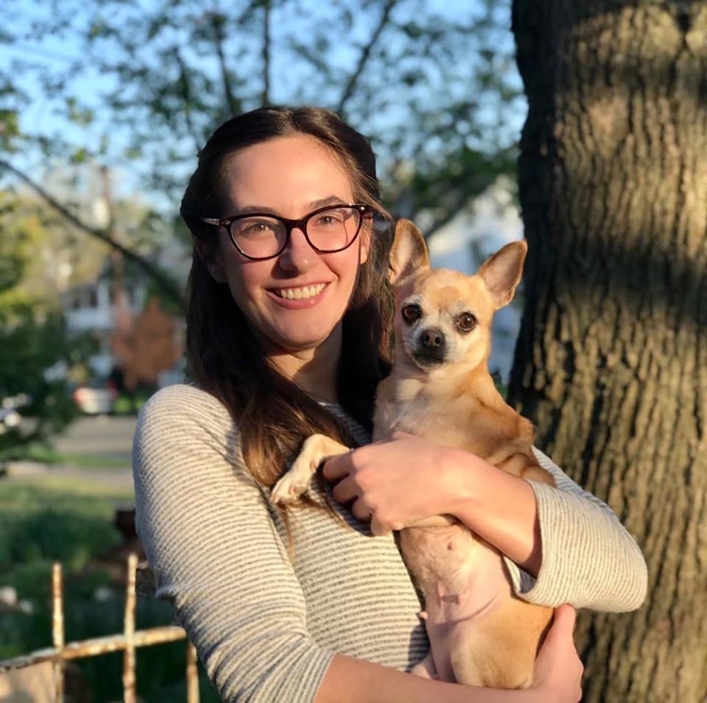Photo of Lauren Semanchik holding a small dog.