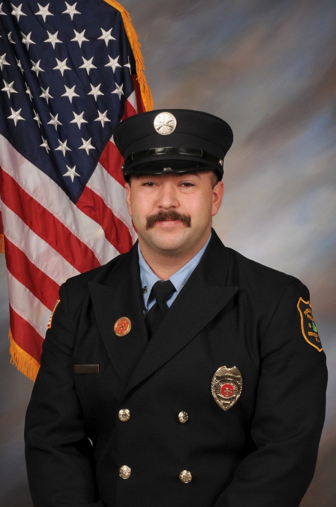 Portrait of Tyler Webb in a firefighter's uniform.