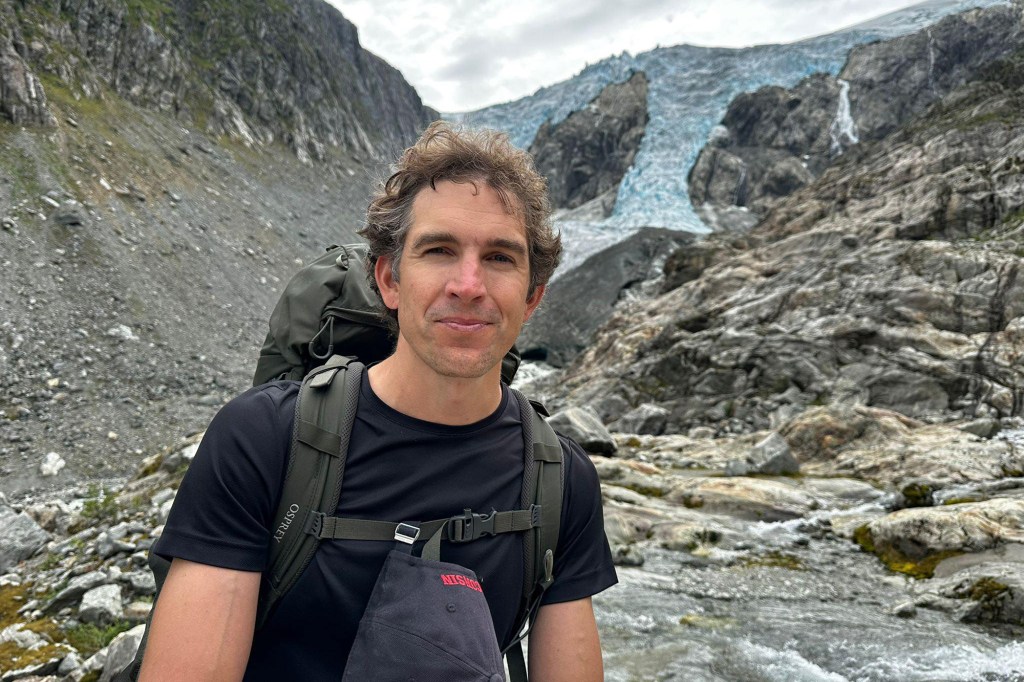 Rescued hiker Alec Luhn in front of a glacier.