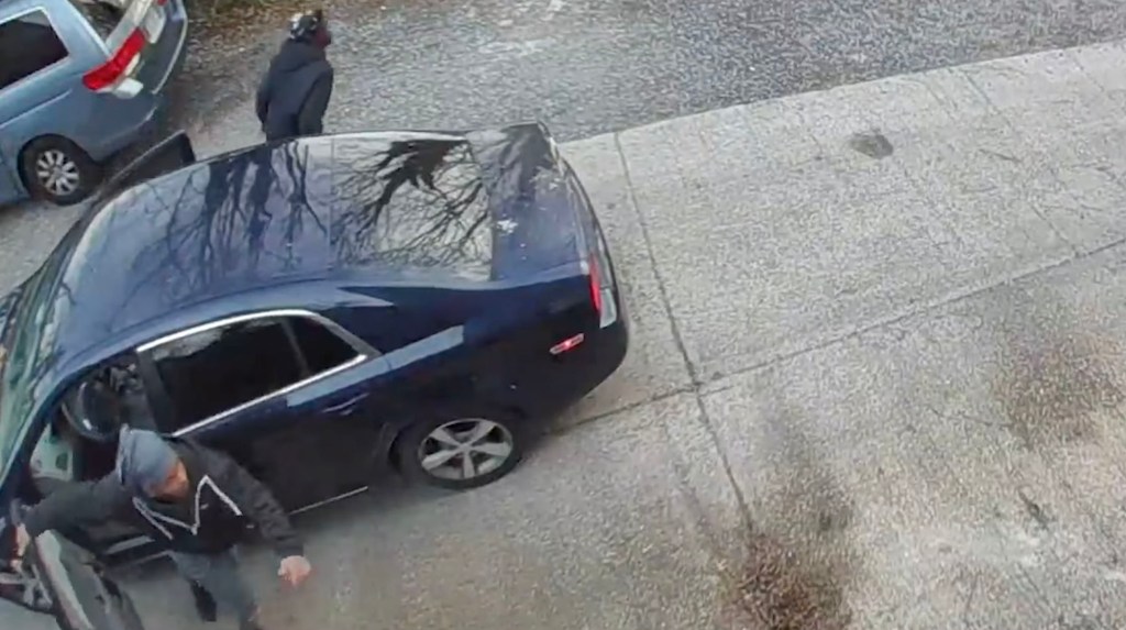 Surveillance footage of an armed carjacking.