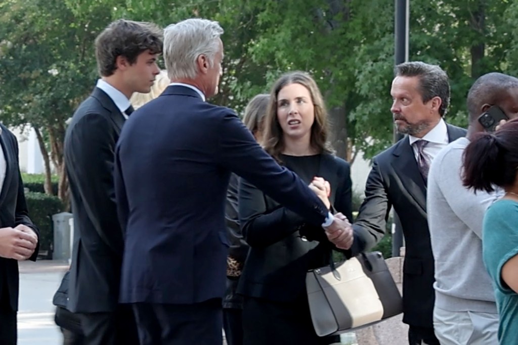 Alan Jackson greeting Frazer Bohm and his family at a courthouse.