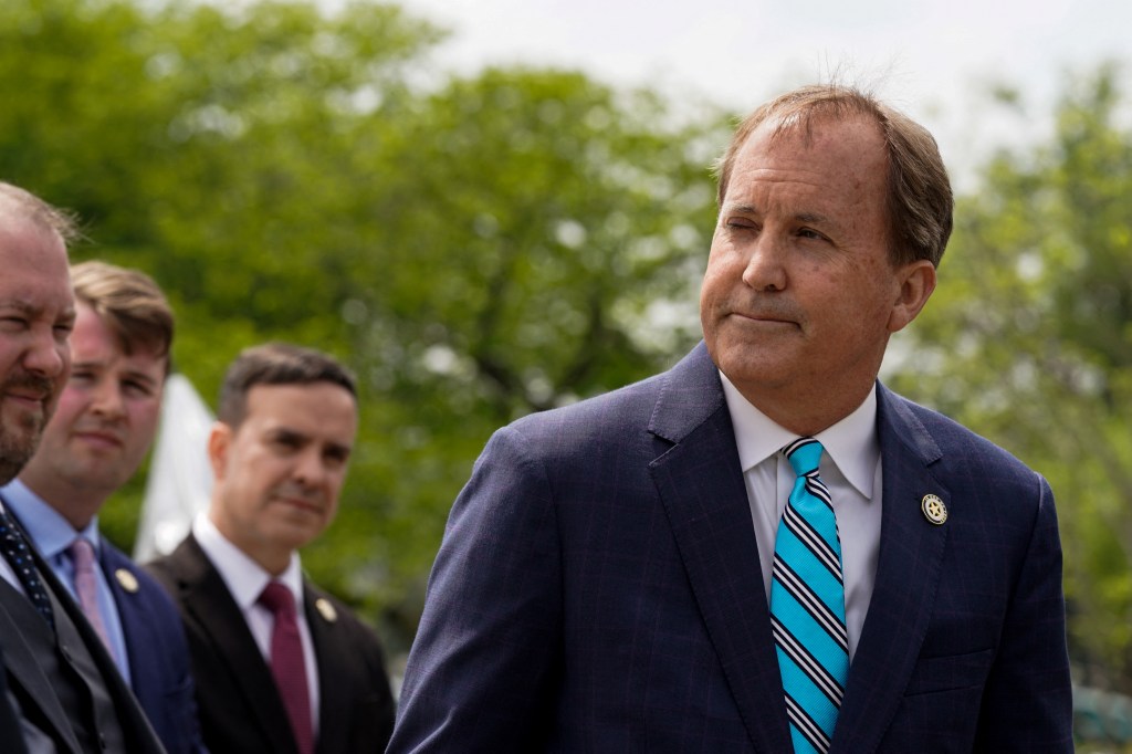 Texas Attorney General Ken Paxton pauses while speaking during a news conference after the U.S. Supreme Court heard oral arguments in President Joe Biden's bid to rescind a Trump-era immigration policy that forced migrants to stay in Mexico to await U.S. hearings on their asylum claims, in Washington, U.S., April 26, 2022.
