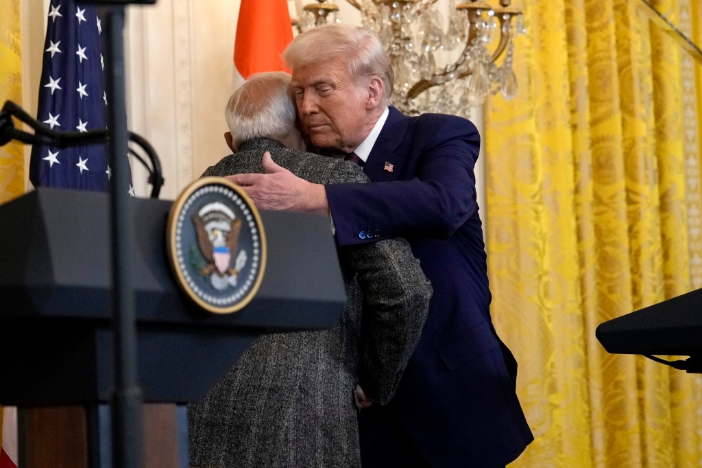 President Donald Trump, right, hugs India's Prime Minister Narendra Modi during a news conference in the East Room of the White House, Feb. 13, 2025,