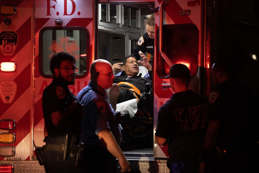 First responders place a man into the back of an ambulance after rescuing him from the boat at Pier 1.