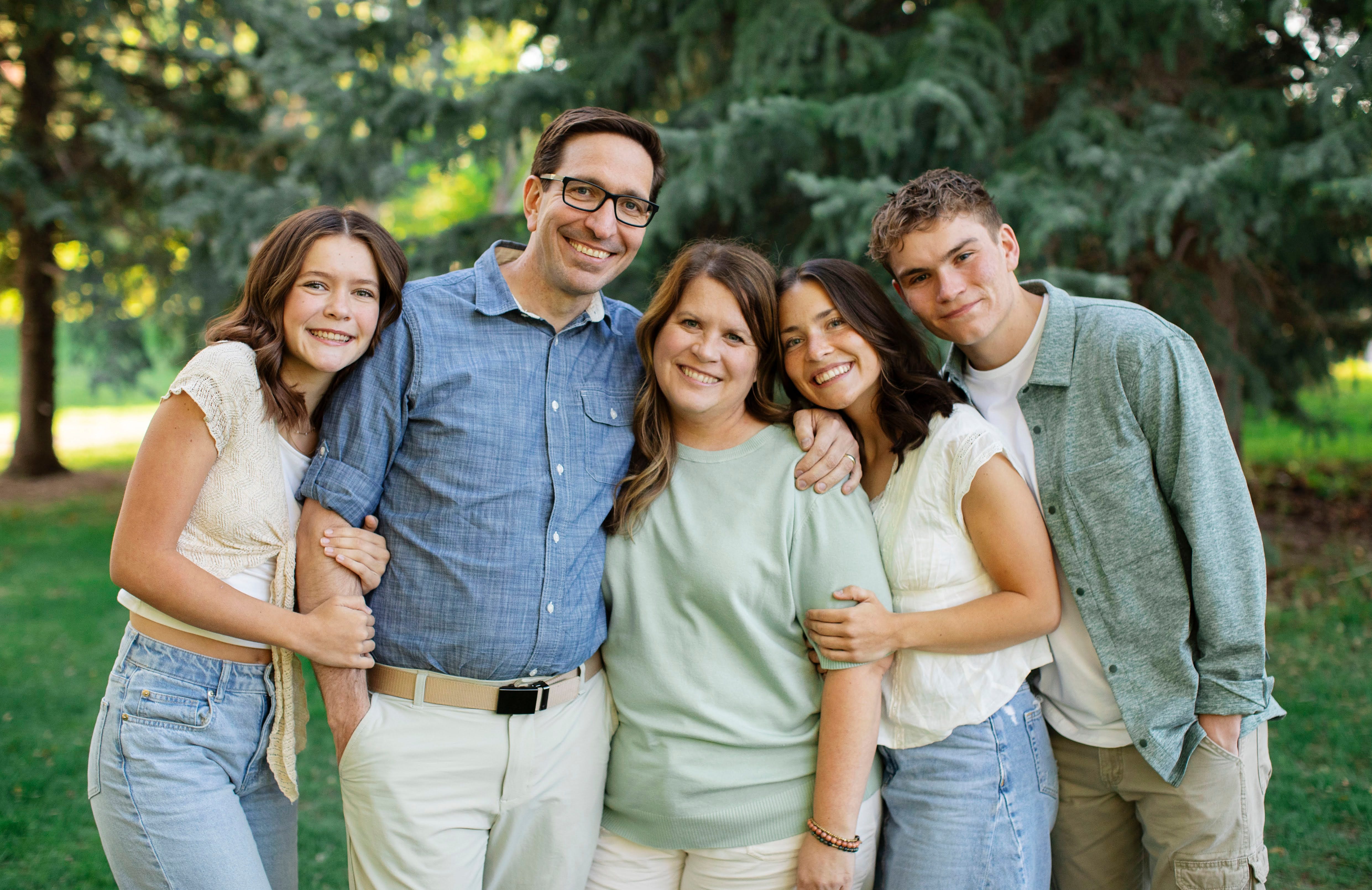 Cache Merrill and his family smile for a family photo