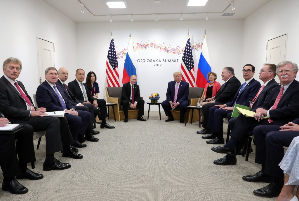 Russian President Vladimir Putin (C-L) and US President Donald Trump (C-R) hold a meeting on the sidelines of the G20 summit in Osaka on June 28, 2019.