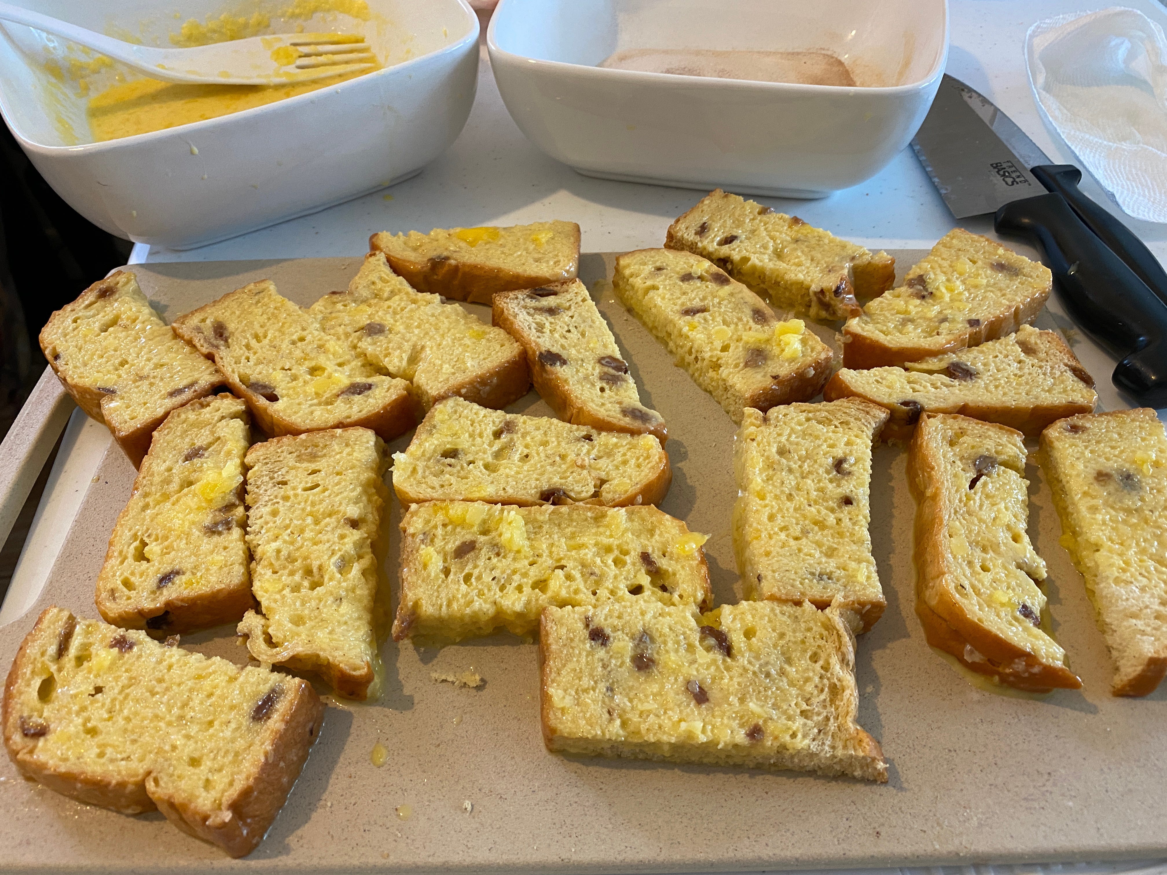 dipped french toast laid out on parchment paper