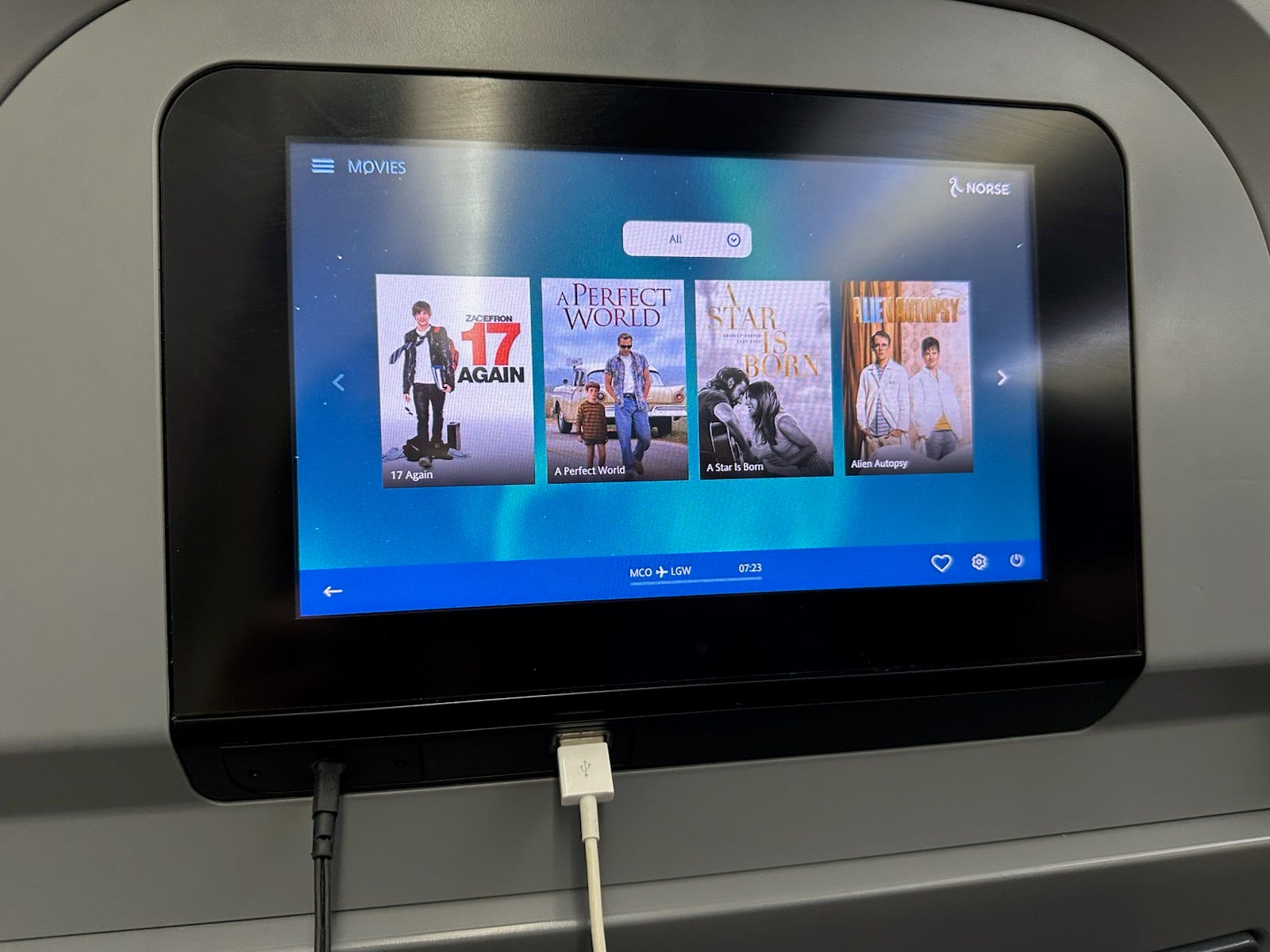 in-flight entertainment screen with charger plugged into it