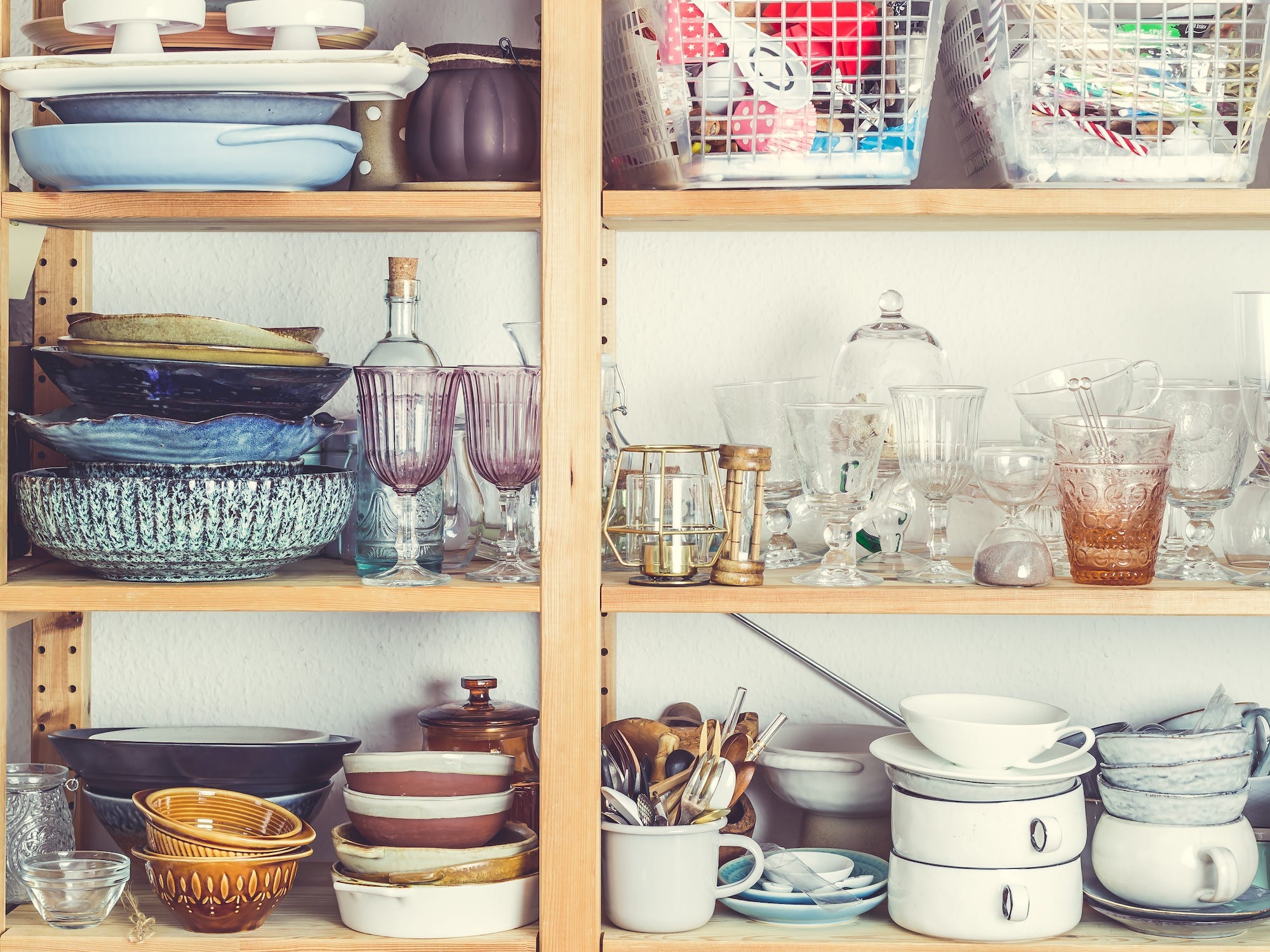 A cabinet full of mismatched glassware.