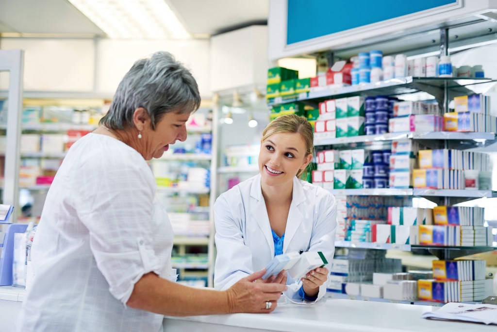 Pharmacist explaining medication to a patient.