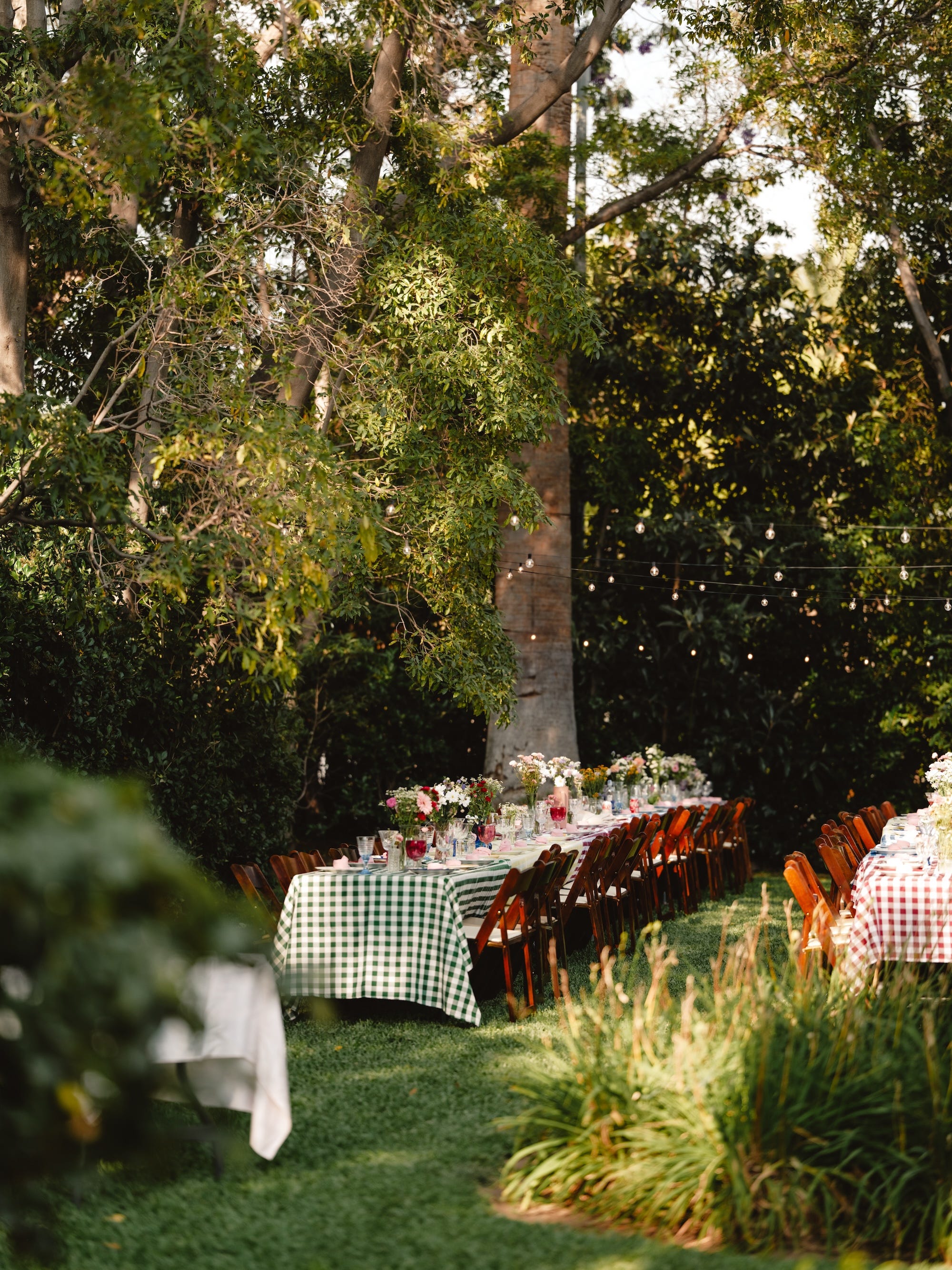A backyard with tables set up for a wedding.