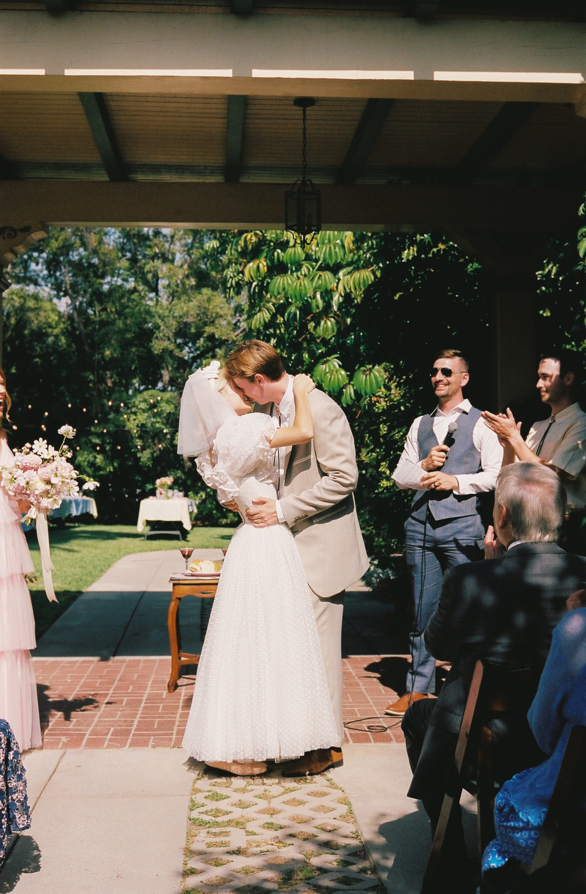 A couple kisses during their wedding ceremony.