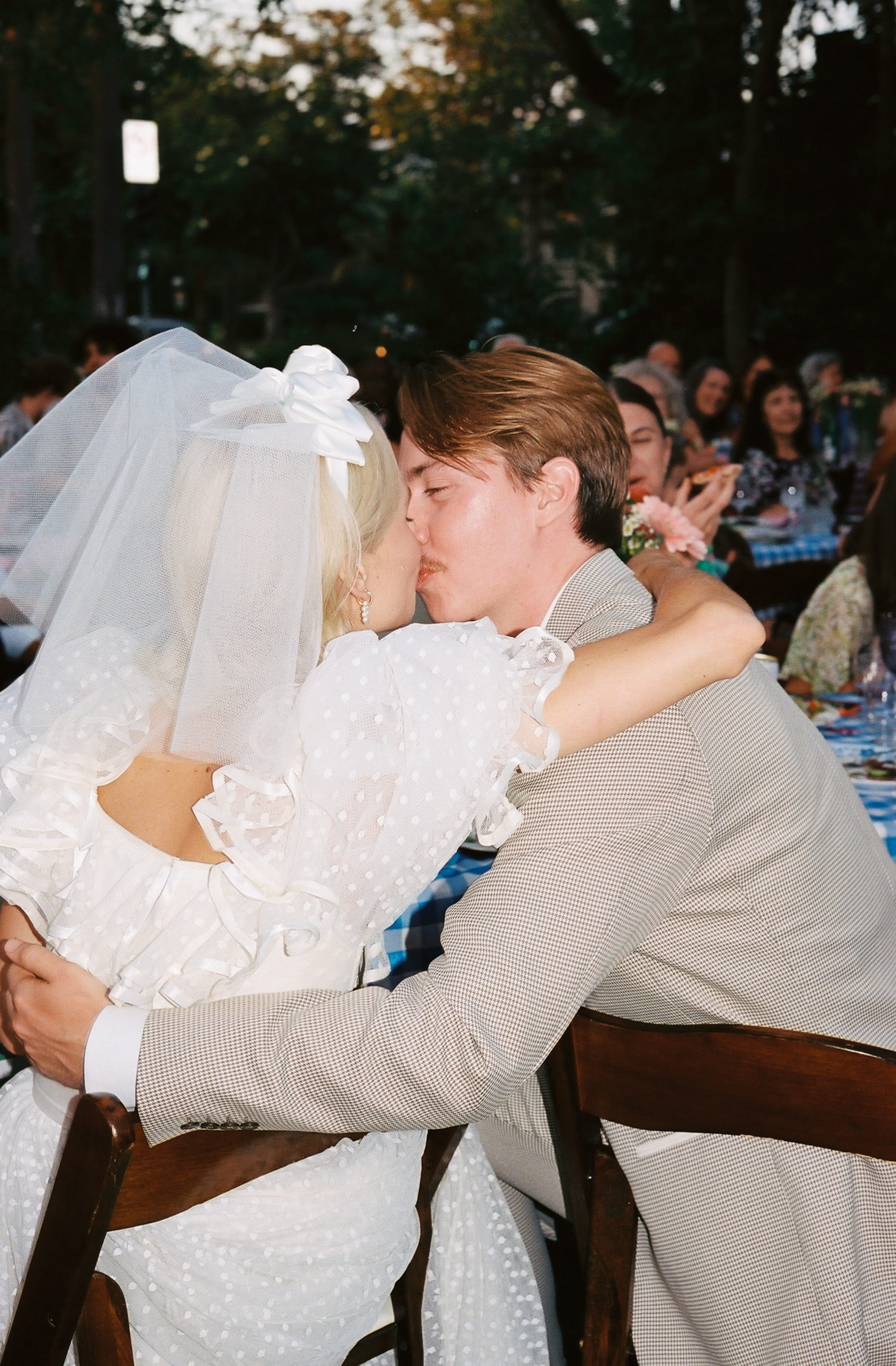 A bride and groom kiss at their wedding reception.