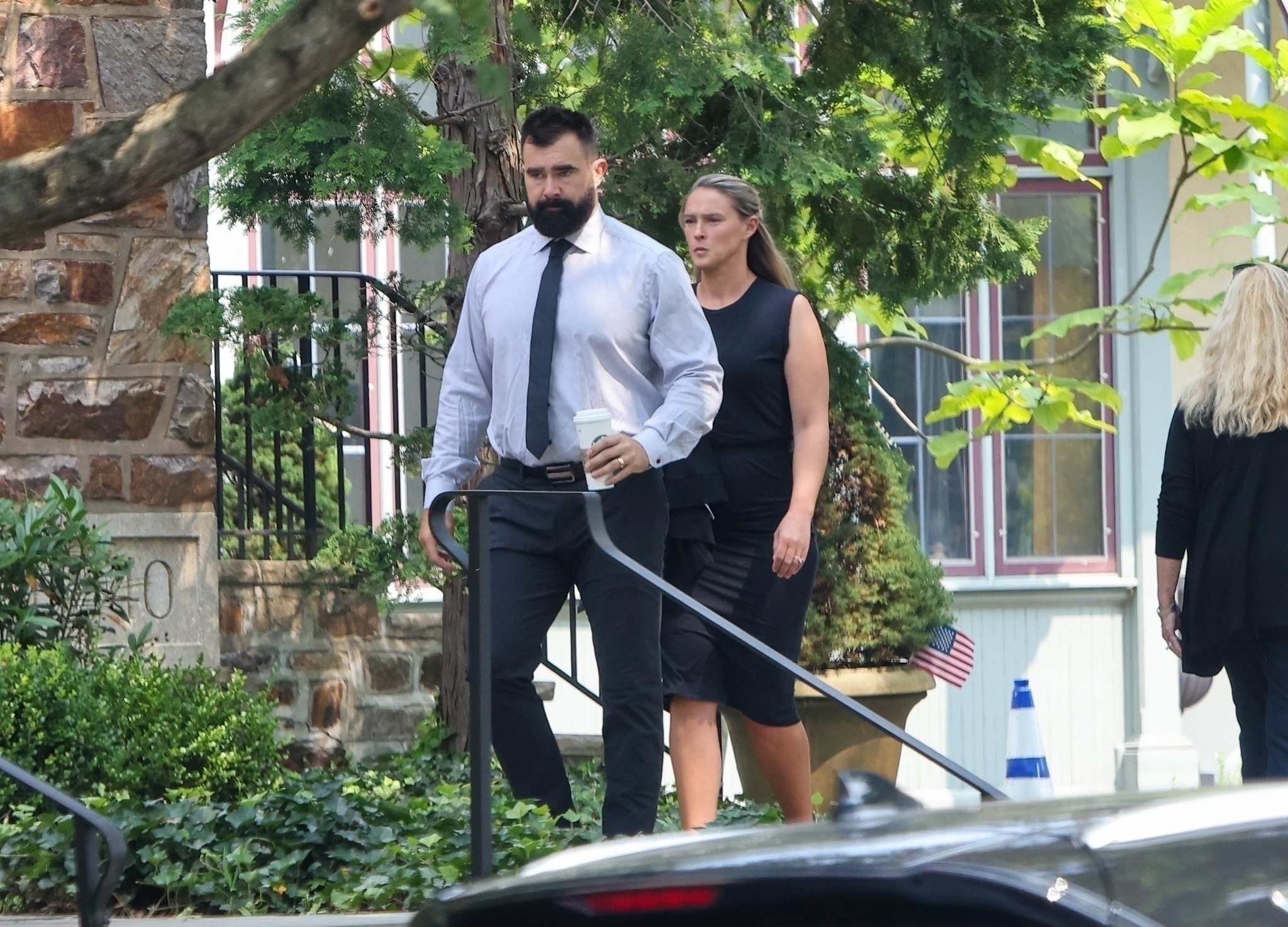 Jason and Kylie Kelce walk outdoors. 
