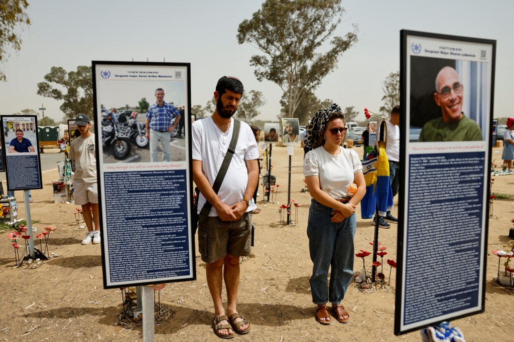 Mourners observe Memorial Day at a memorial site in Reim, Israel.