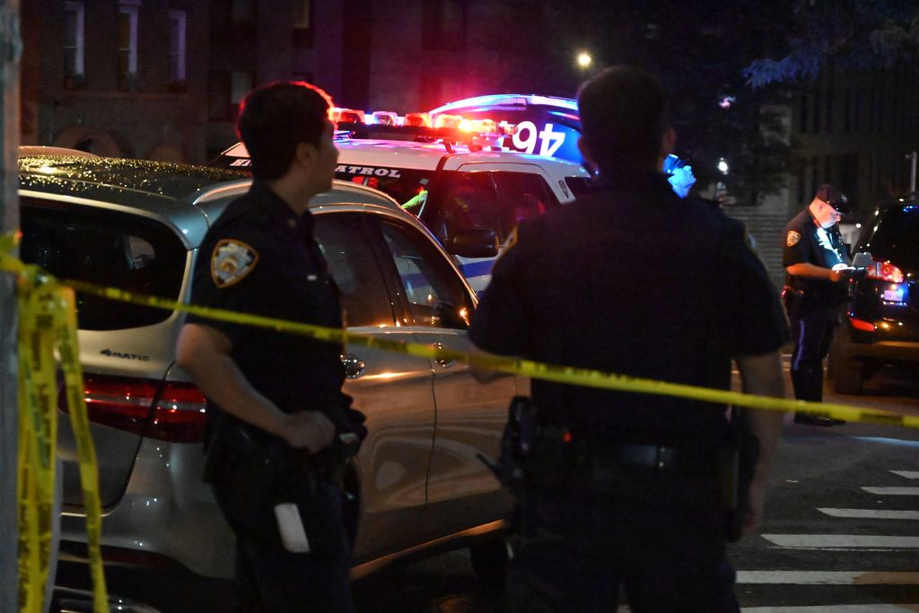 Police officers at a night time crime scene.