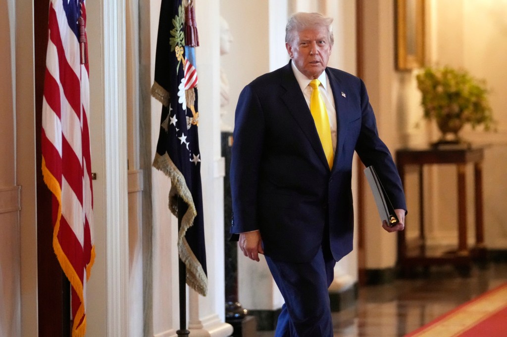 Donald Trump walking in the White House.