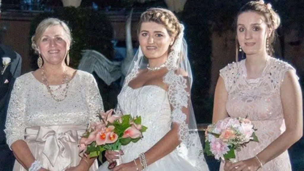 Photo of three women at a wedding.