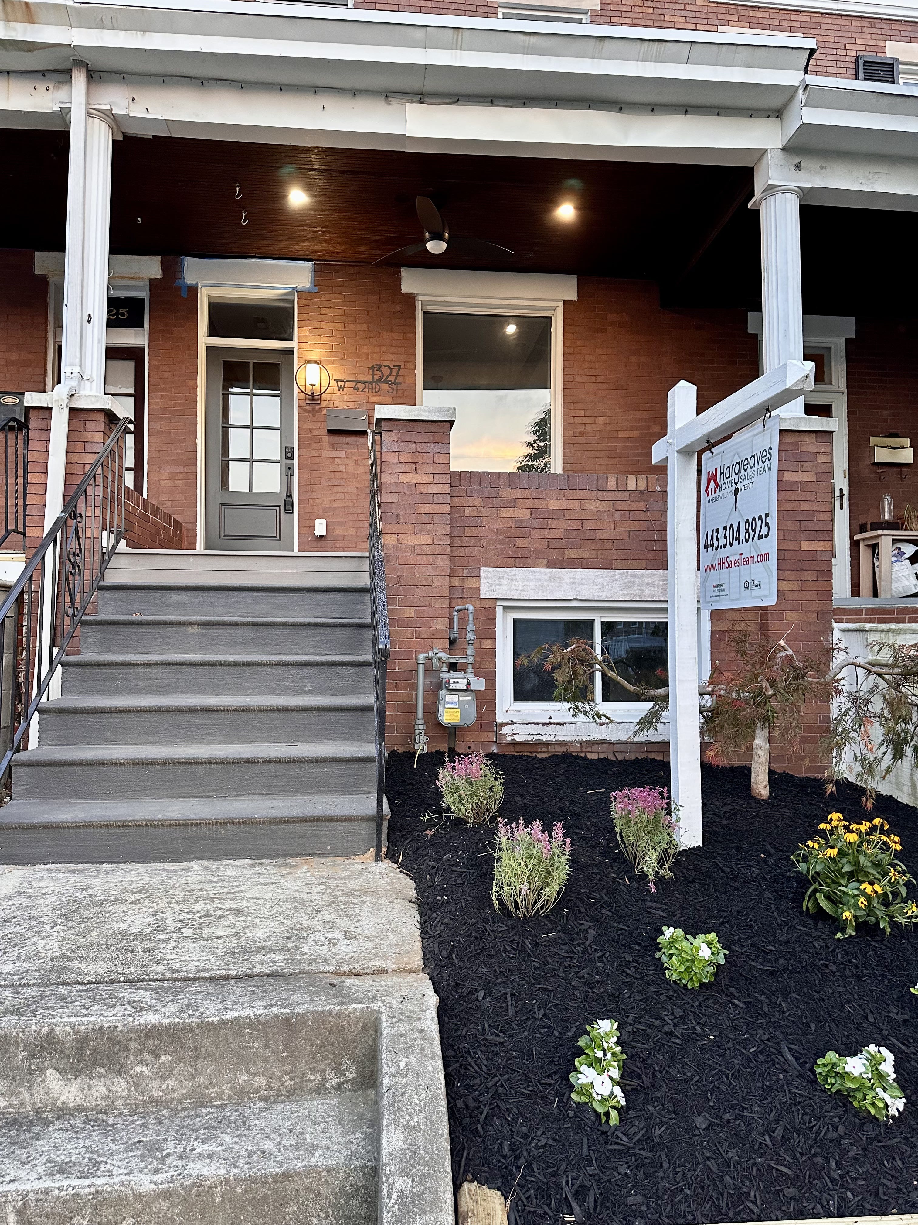 brick house with a sign out front