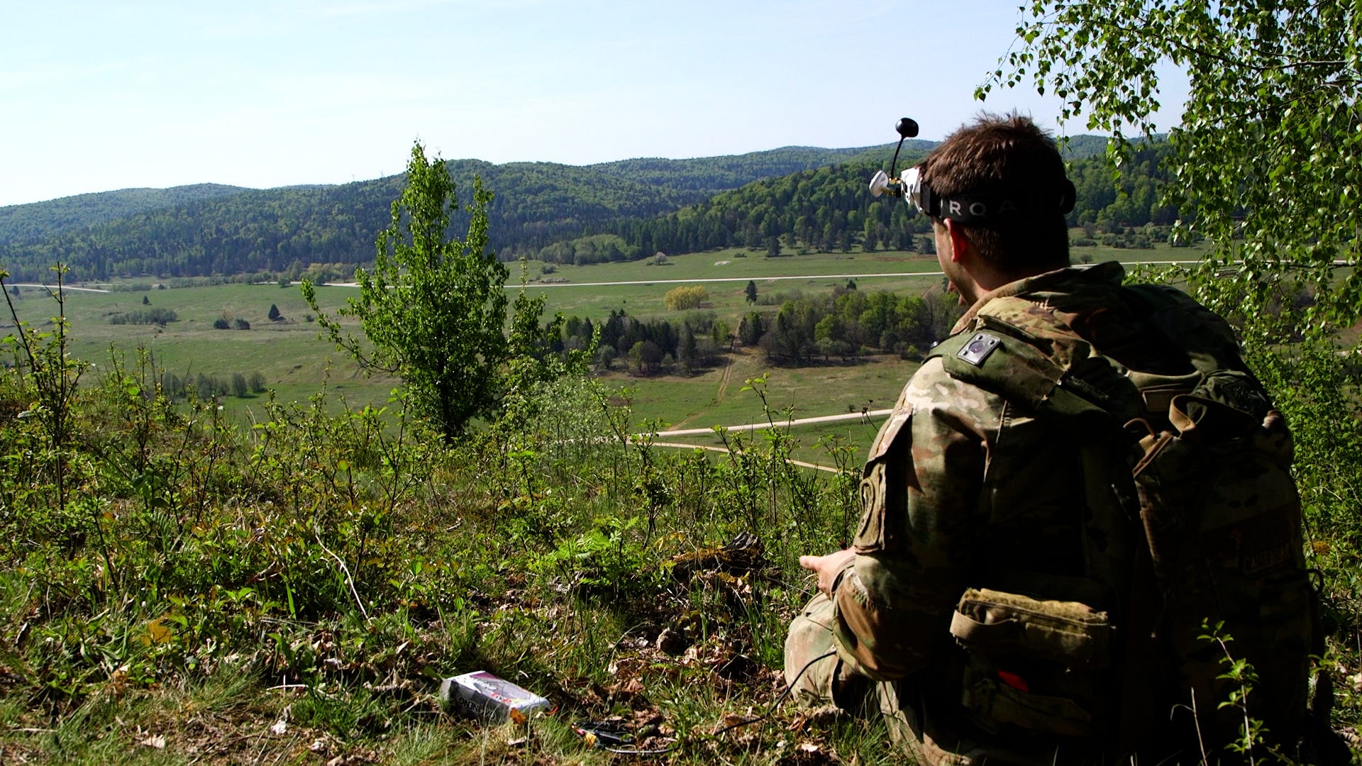 A US Army soldier looks out over a training area.