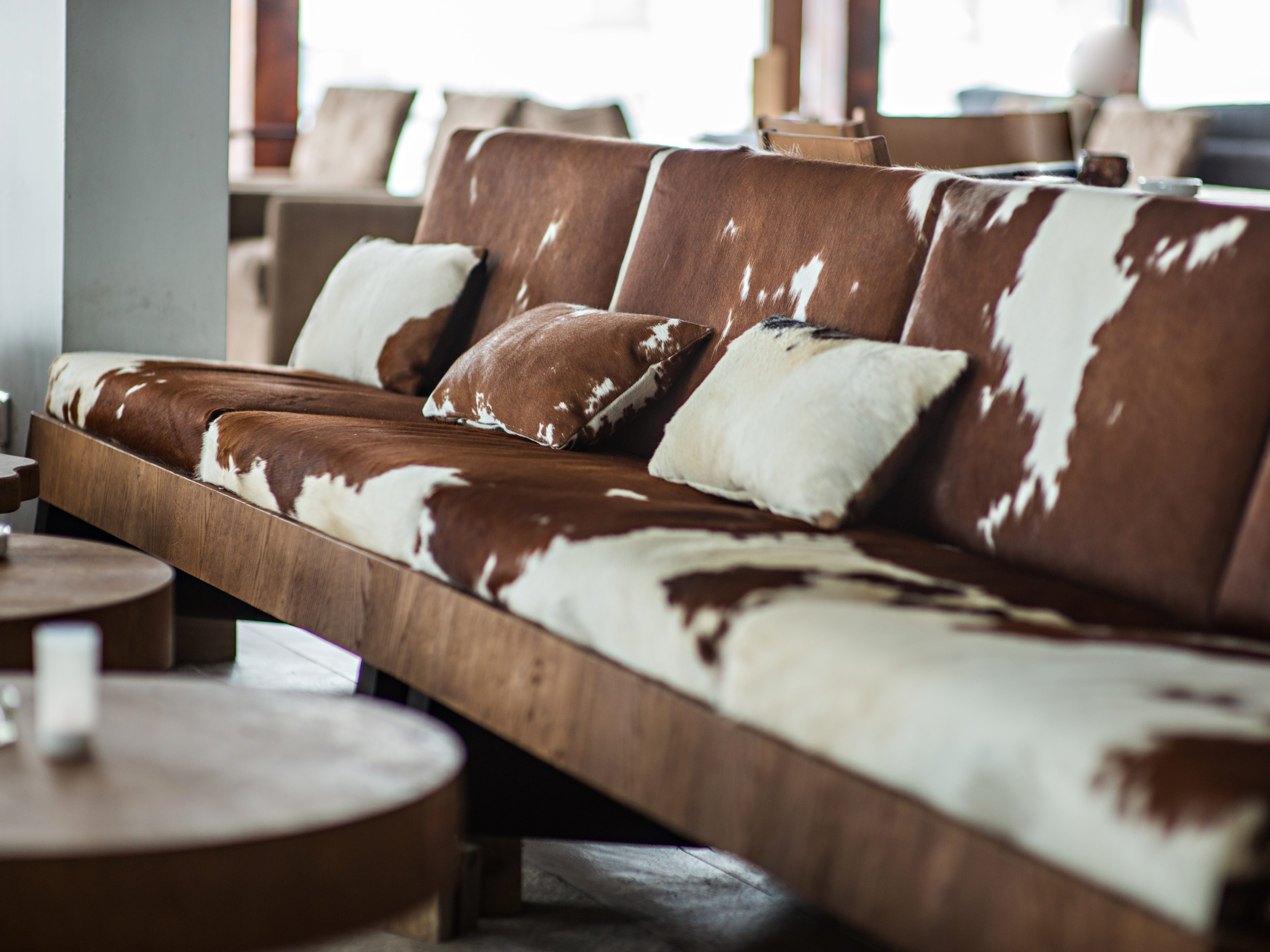 A brown-and-white cow print sofa