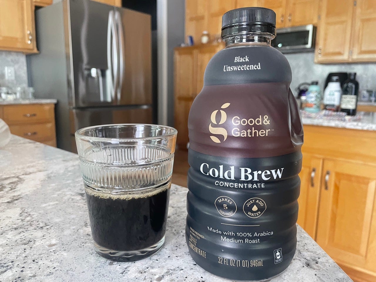 Good and Gather cold brew bottle next to glass of cold brew