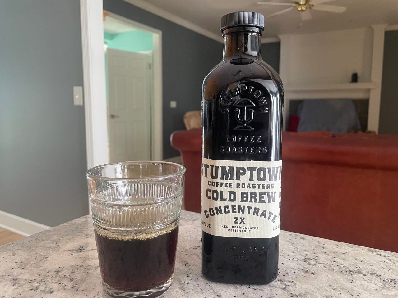 Stumptown cold brew bottle next to glass of cold brew