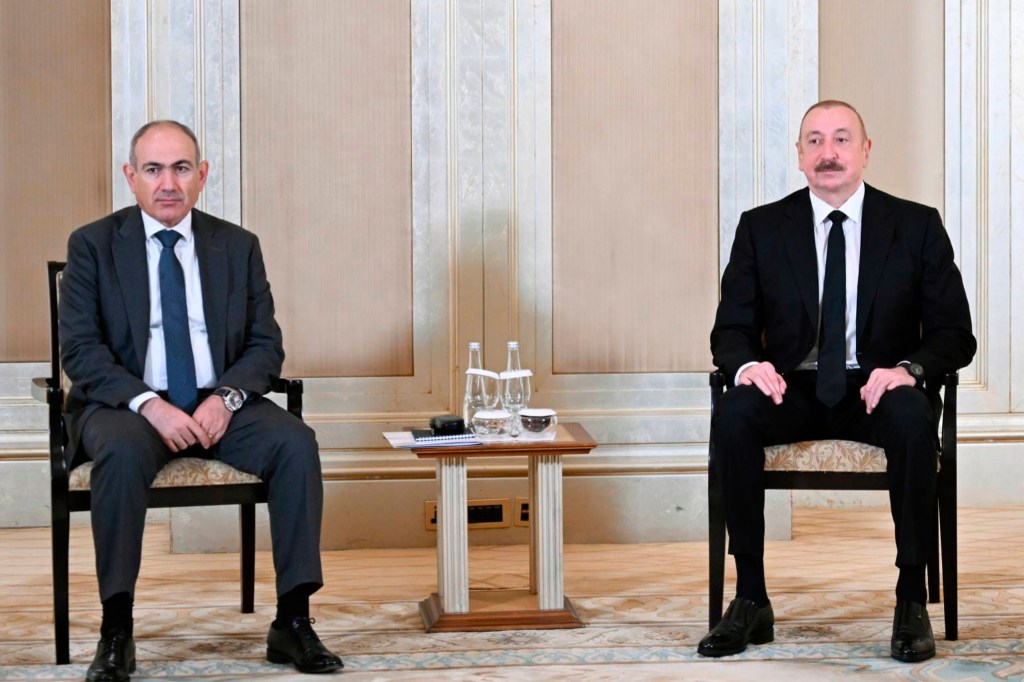 Presidents Ilham Aliyev and Nikol Pashinyan sitting for a photo.