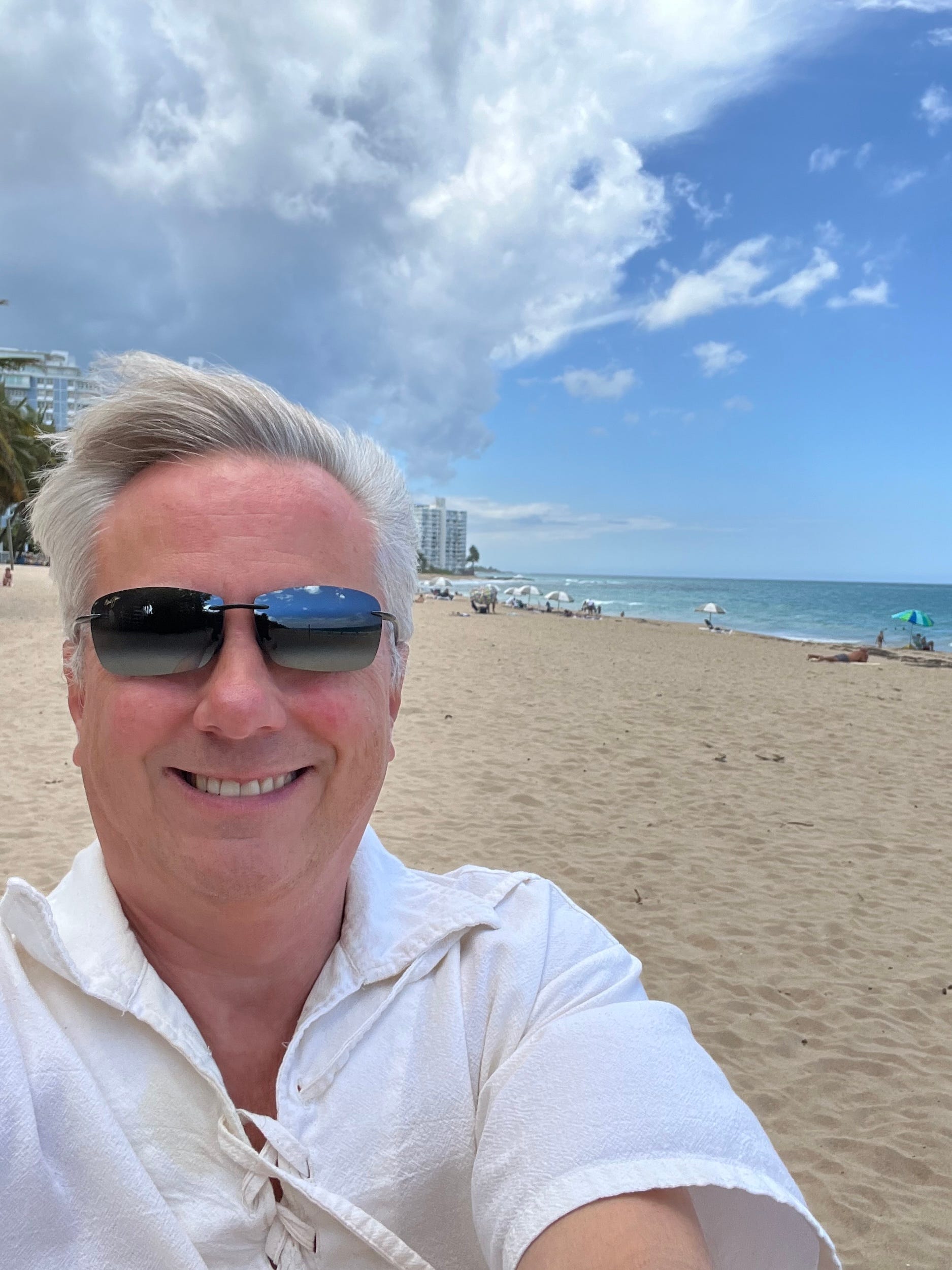 A selfie of a man on a beach.
